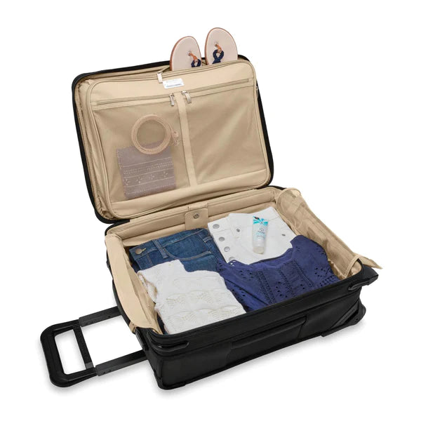 The Briggs &amp; Riley Baseline 21" 2-Wheel Expandable Carry-On is filled with clothes for an extended vacation. All the clothes are neatly organized in each compartment.